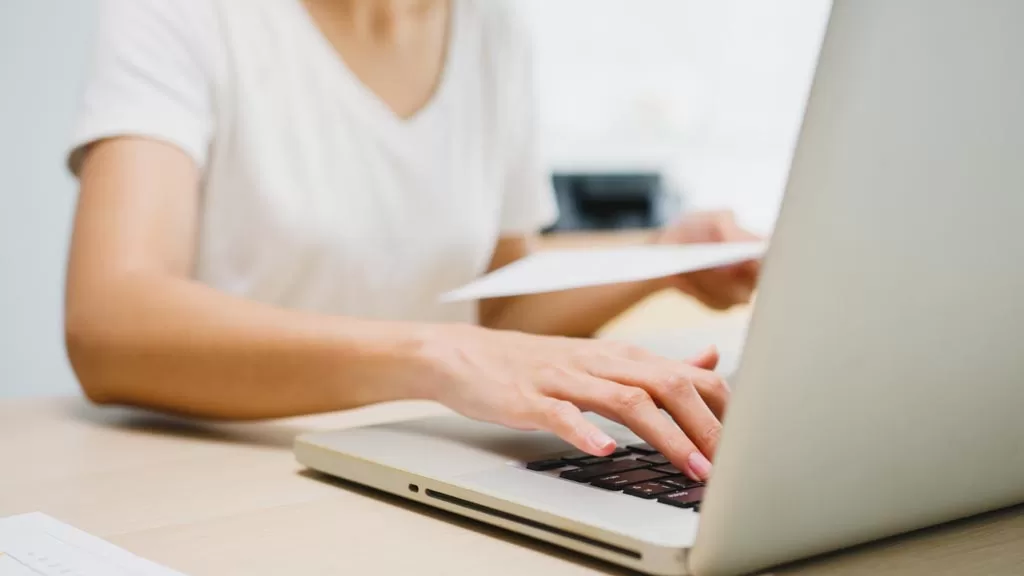 Freelance young Asia businesswoman casual wear using laptop working in living room at home. Working from home, remotely work, self isolation, social distancing, quarantine for corona virus prevention.